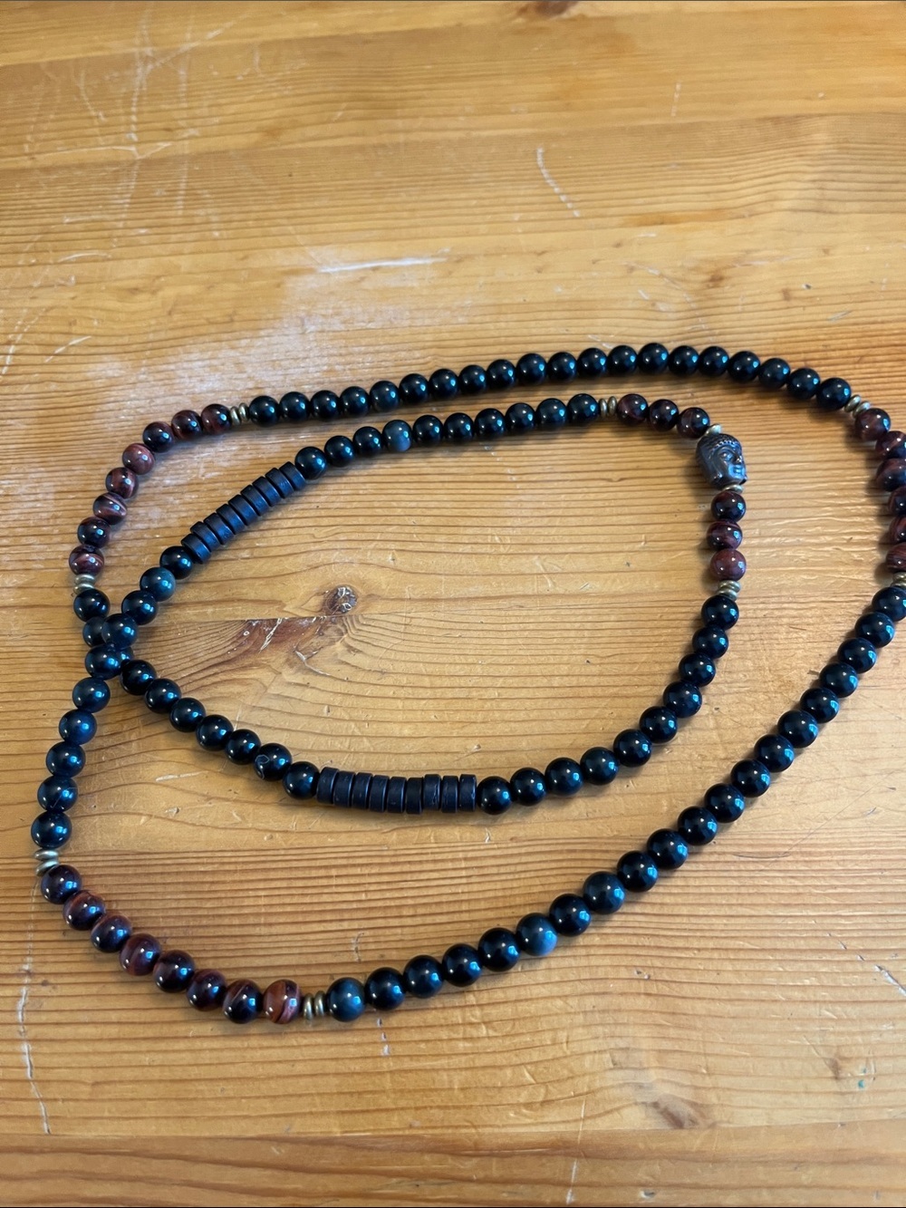 Buddha necklace in brown and black beads.